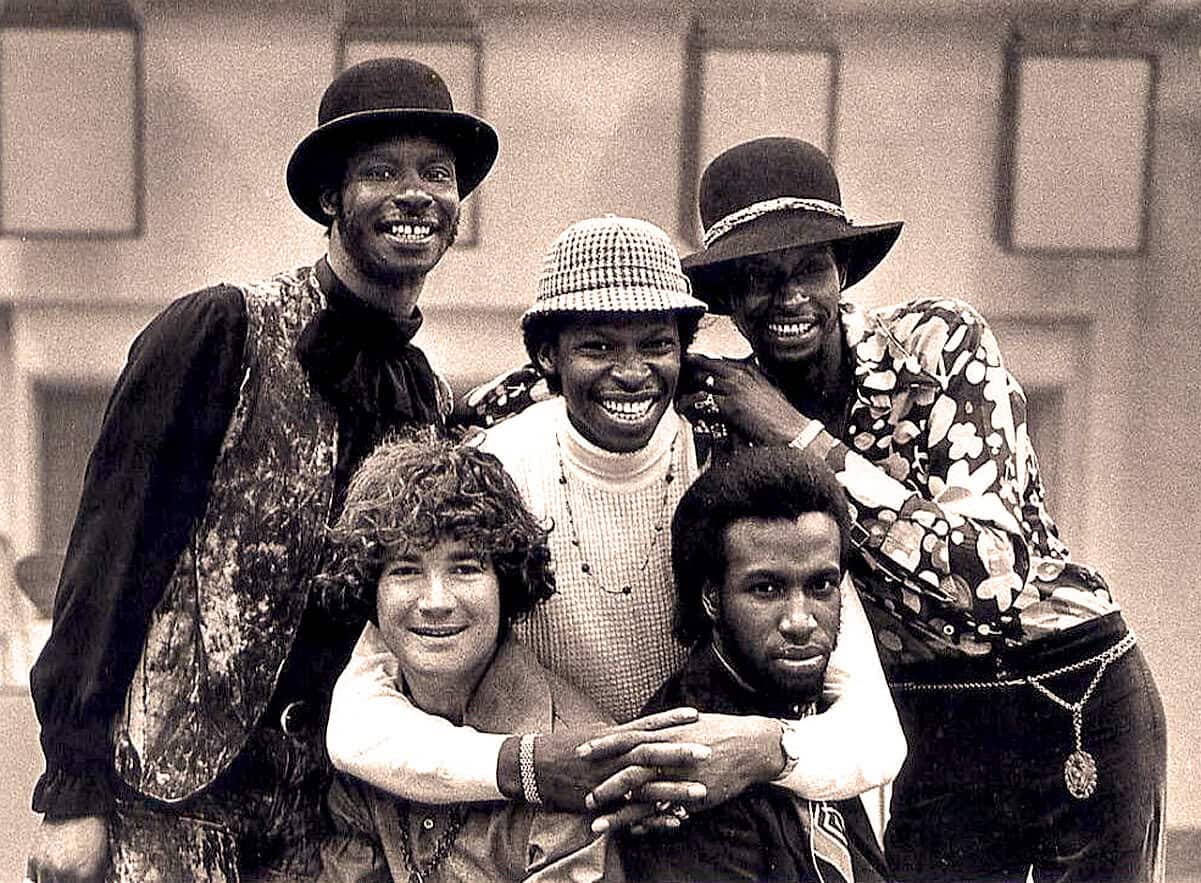 African American musicians in vintage attire, showcasing cultural diversity and musical history, with a nostalgic black-and-white photograph emphasizing the legacy of classic music eras.