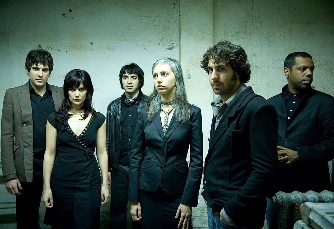 Dark Waves band members in a gritty, industrial setting, promoting indie rock and alternative music with a focus on news, history, and music recordings from Past Daily archive.