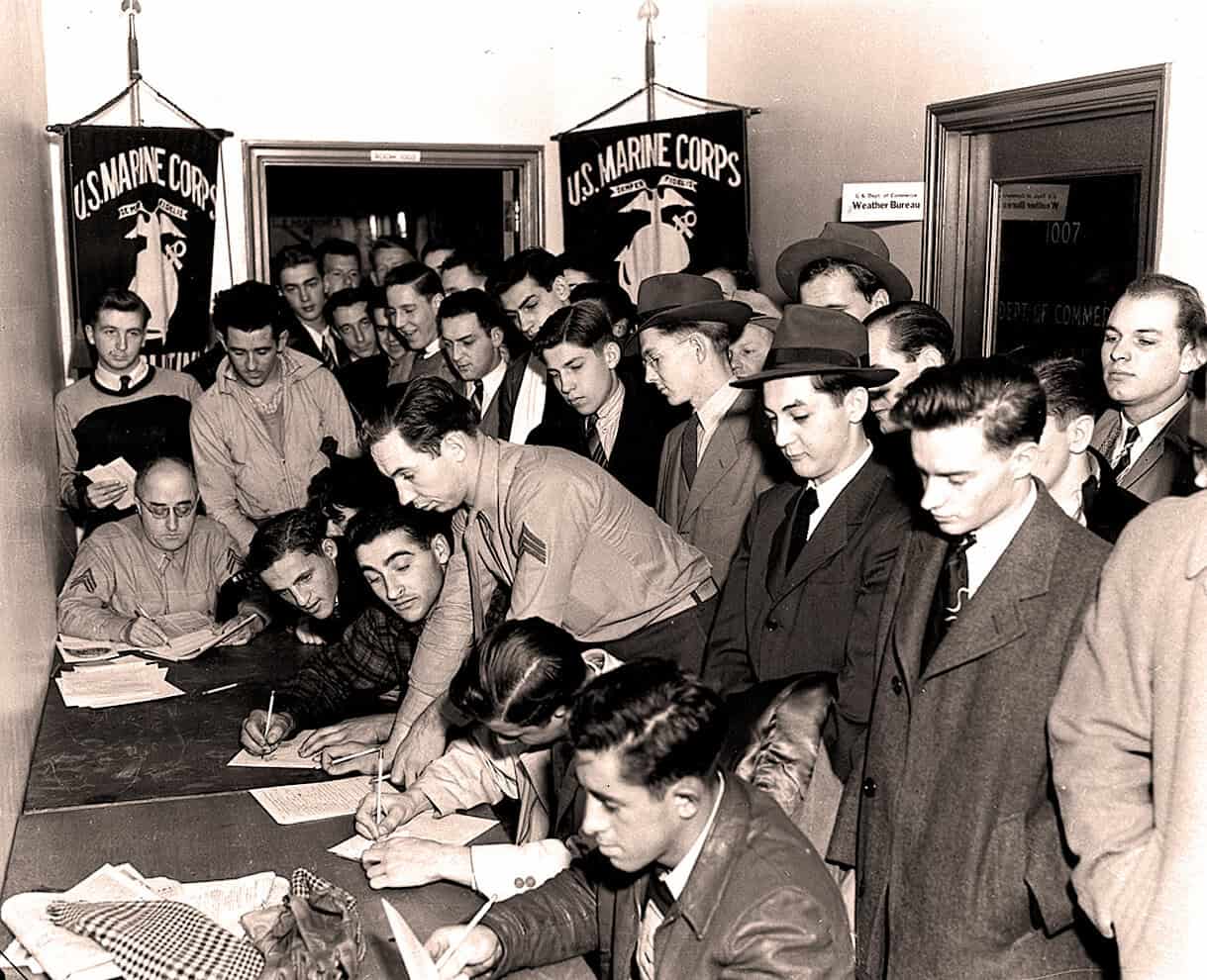 U.S. Marine Corps recruitment office during World War II, vintage black and white photo with young men signing enlistment papers, symbolizes military history and patriotism.