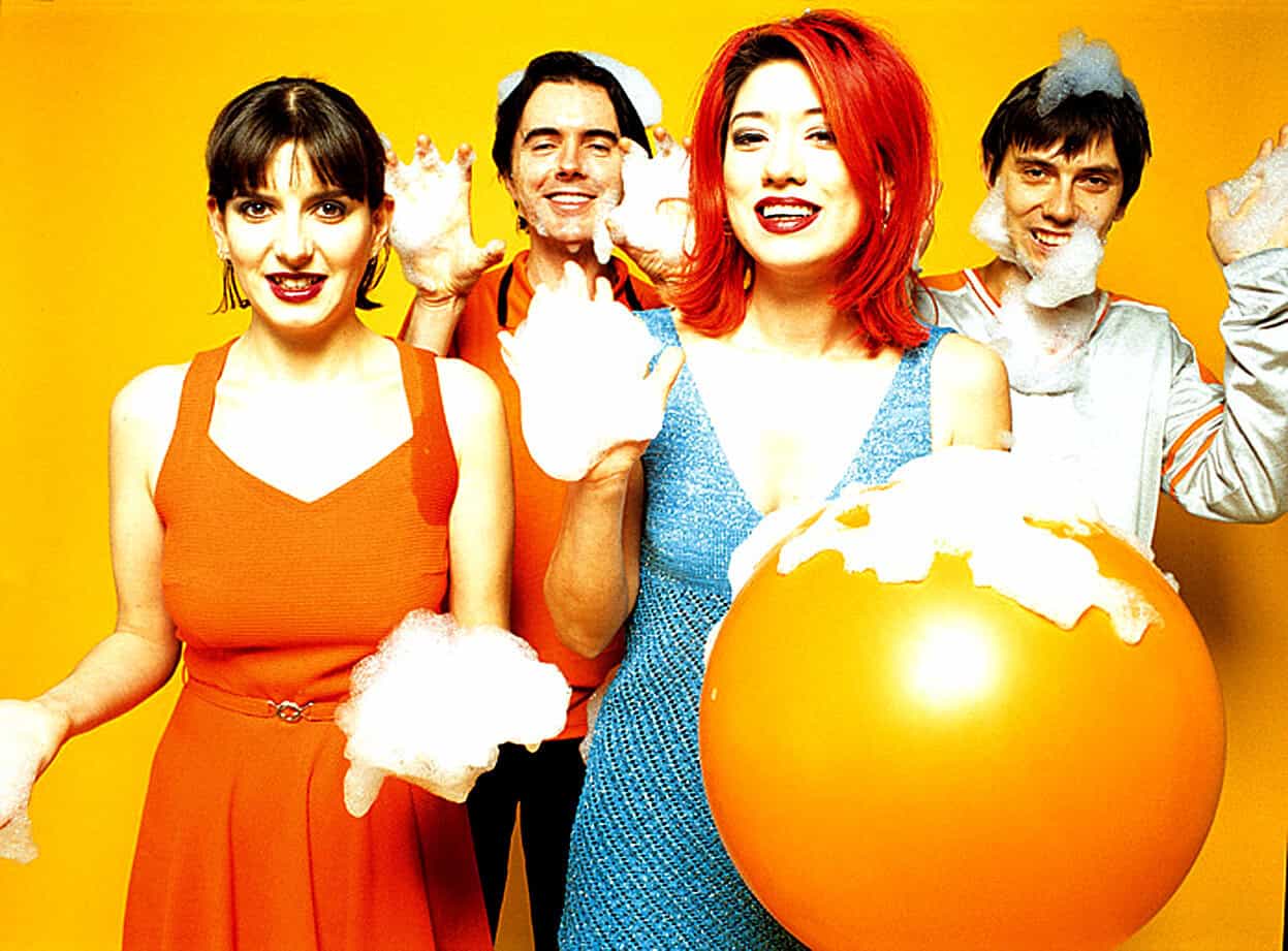 Playing with foam bubbles, cheerful family enjoying bath time, happy kids and mother with soap suds, colorful background, joyful moments, family fun, clean play, childhood happiness, bathing time, leisure activity, playful family portrait.