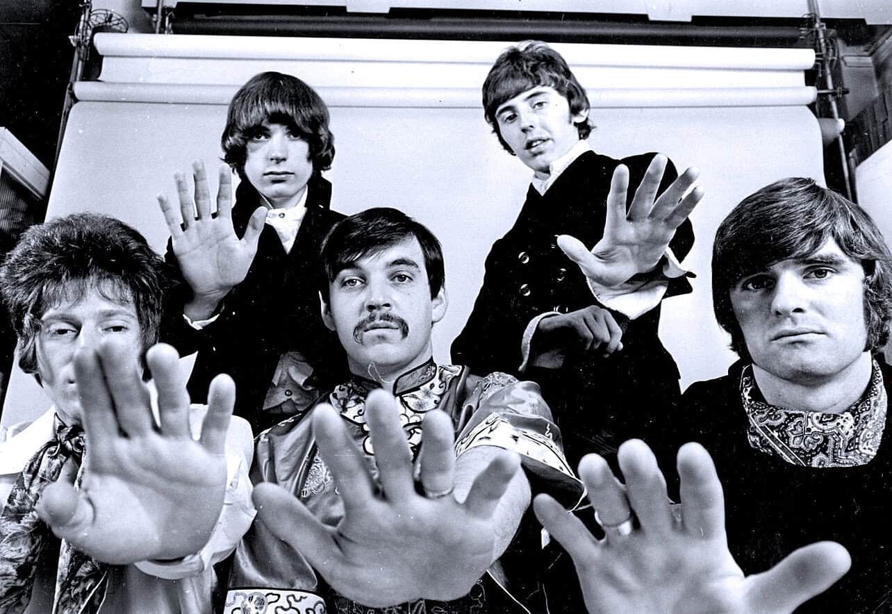 1960s British rock band The Beatles with members John Lennon, Paul McCartney, George Harrison, and Ringo Starr, engaged in photo shoot for music history and iconic music band imagery.