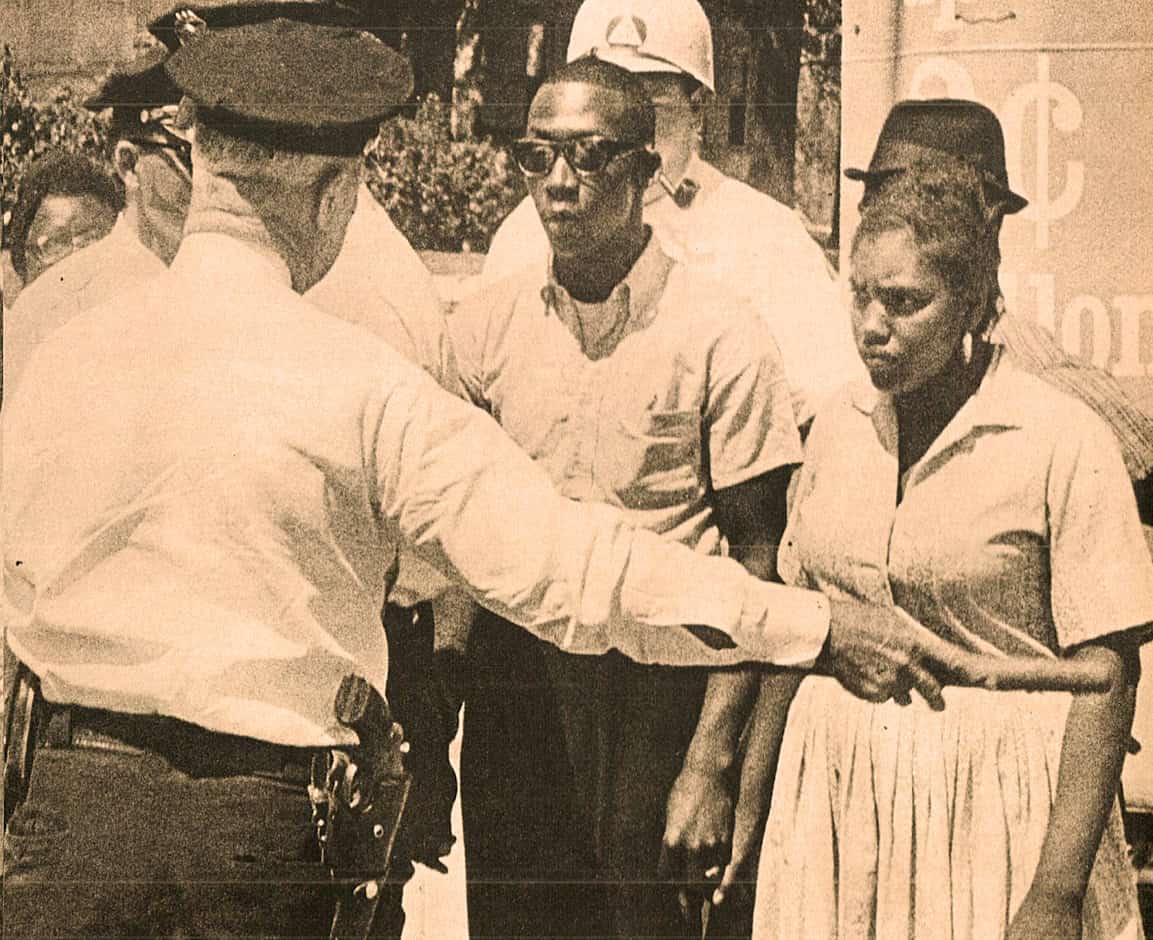 Police officer and protesters during civil rights demonstration in the 1960s.