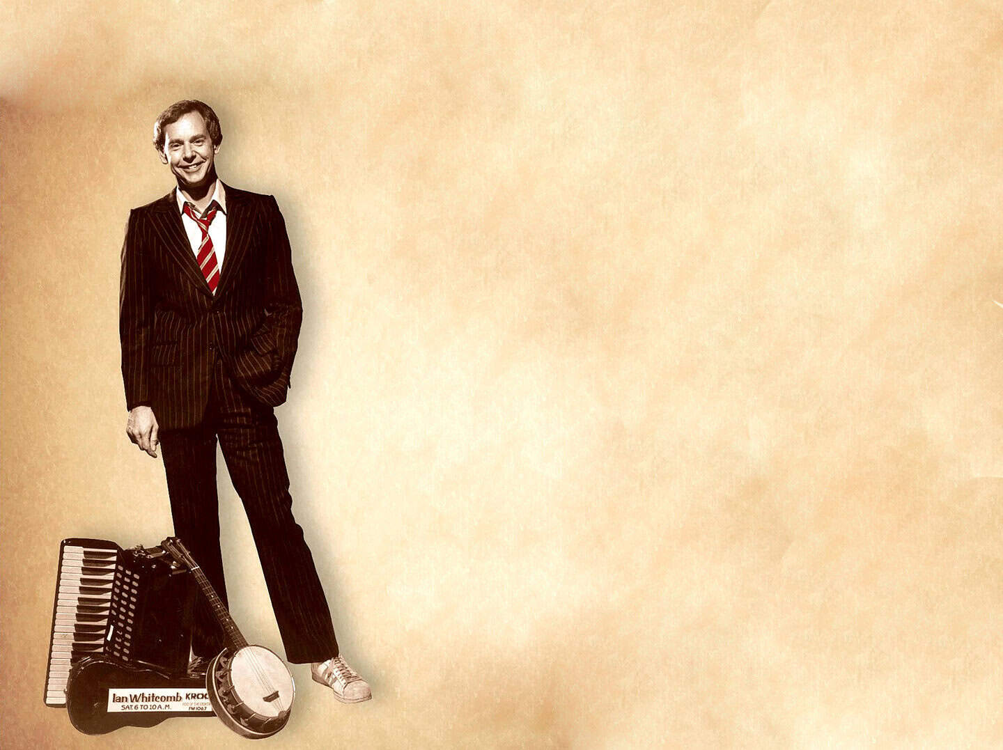 Vintage photo of a man in a pinstripe suit with accordion and radio, representing vintage music and radio broadcasting, associated with historical sound archives from Past Daily.