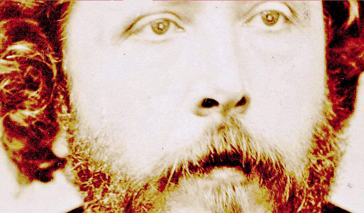 Close-up portrait of a man with a full beard and piercing eyes, emphasizing historical and cultural significance for vintage photo, classic look, nostalgic imagery, and heritage education.