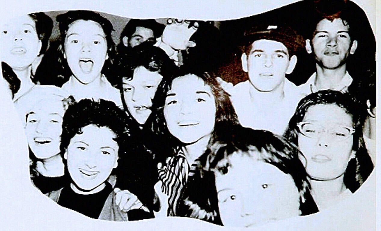 People smiling at a gathering, diverse group of friends enjoying a moment together, candid photo capturing happiness and friendship, ideal for nostalgic and social history archives at Past Daily.