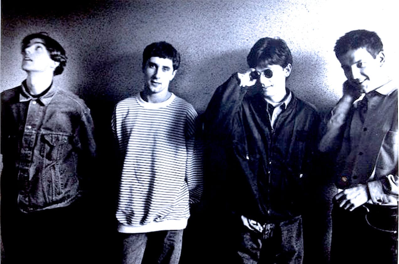 Archive image of four young men in casual clothing, representing music and youth culture.