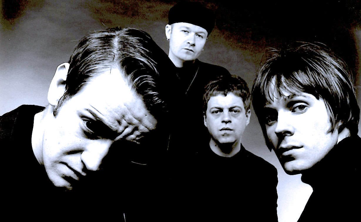 John Doe band promotional photo, alternative rock band members, black and white music band portrait, iconic music history image, past daily sound archive, music and news history.