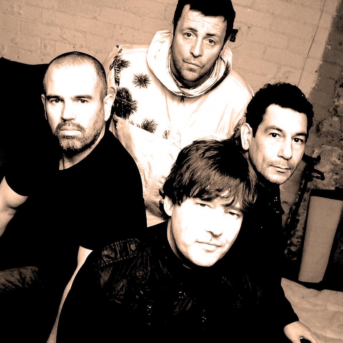 Vintage-style black and white photo of the band Radiohead, showcasing four members with focused expressions, highlighting musical history, iconic rock bands, and music archives relevant to Past Daily.