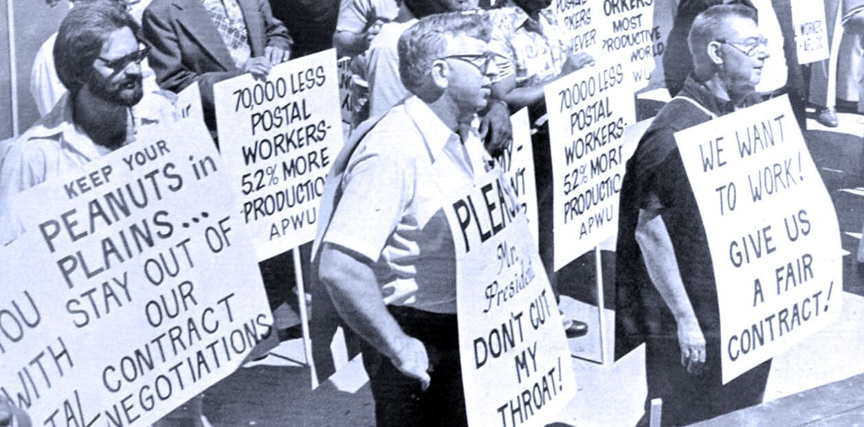 Protesters holding signs demanding fair postal workers' contracts and better working conditions, historical labor strike, historic protest image related to postal service workers' rights, labor movement, news archive.