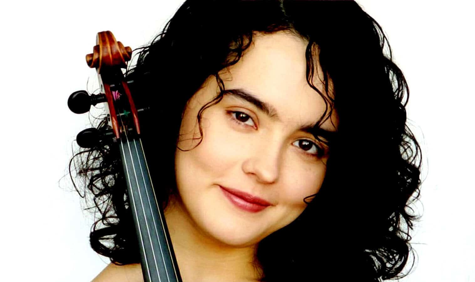 Elegant young woman with dark curly hair holding a violin, emphasizing music, classical instruments, and music history. Ideal for a music archive or historic music content.