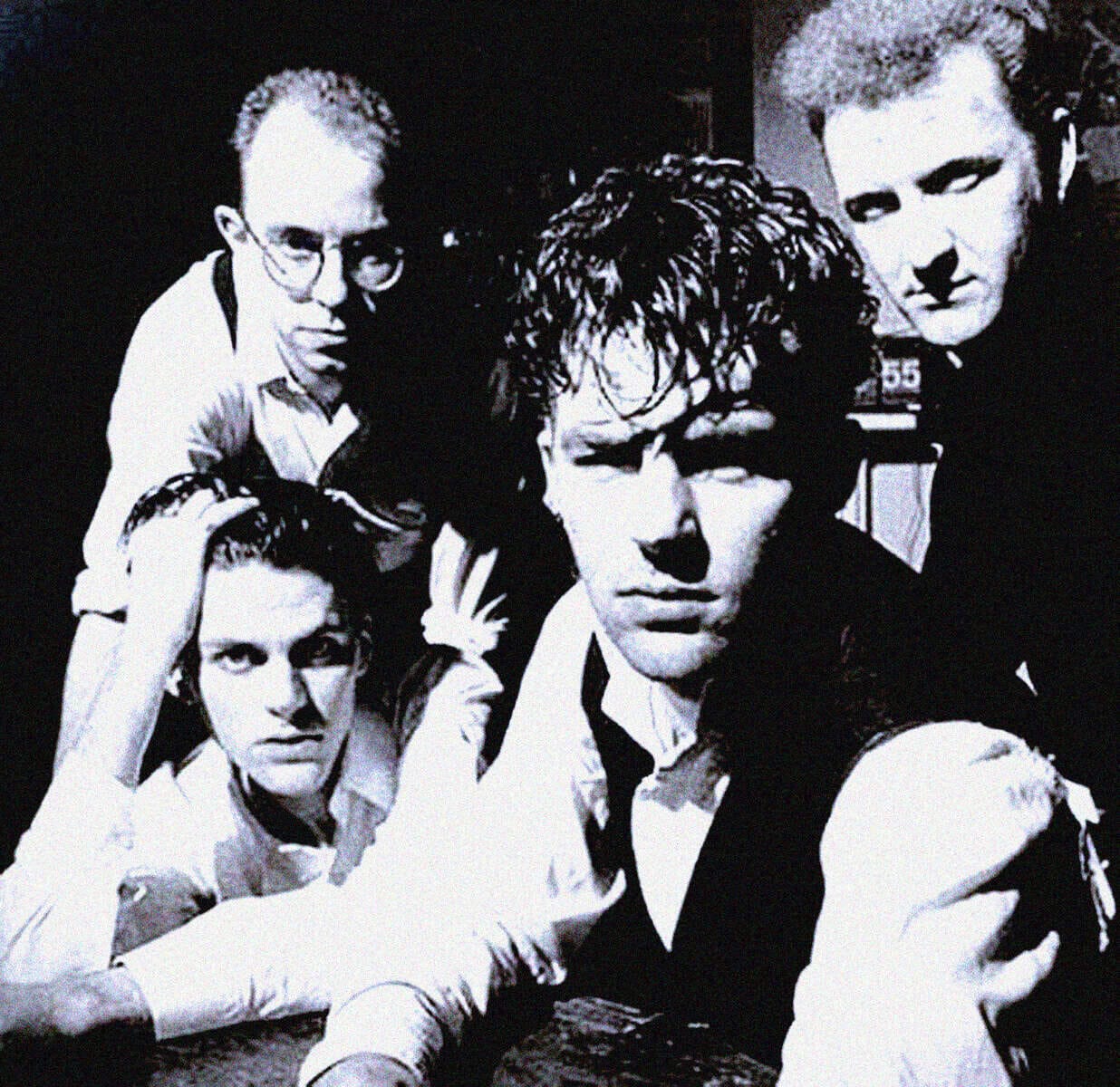 Vintage black and white photo of The Sex Pistols, punk rock band, with members Sid Vicious, Johnny Rotten, Steve Jones, and Paul Cook, showcasing iconic 1970s music history.