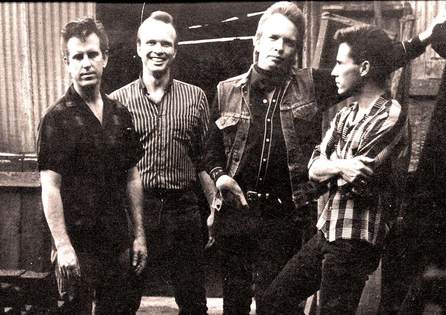 Vintage black and white photo of a punk rock band with four members, showcasing 1980s musical culture, rebellion, and iconic style, emphasizing music history and archives.