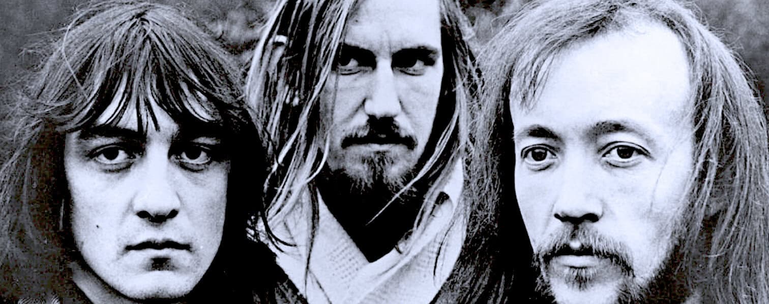 Black and white vintage photo of The Doors band members Jim Morrison, Ray Manzarek, and Robby Krieger, iconic rock musicians from the 1960s, showcasing music history.