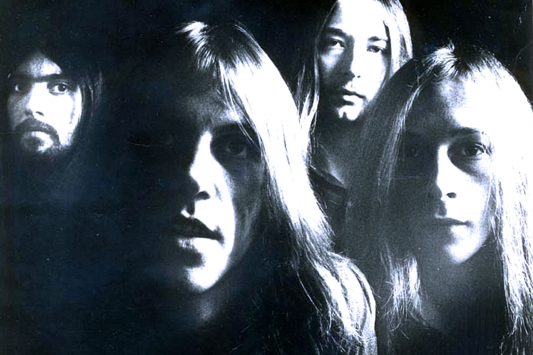 Black and white music band photo showing four members with intense expressions, representing historical news, music archives, and pop culture for SEO.