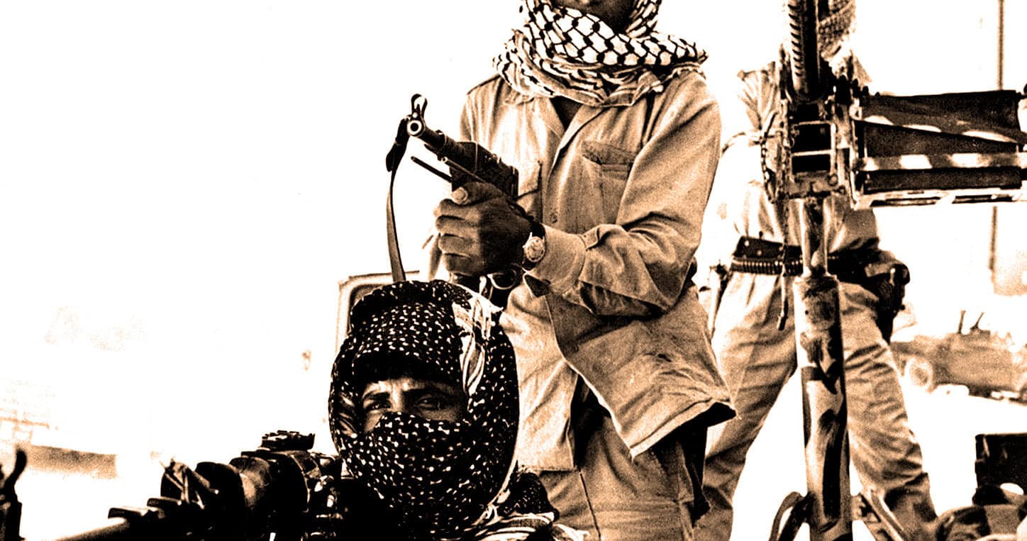 Gun-wielding militant with scarf covering face, armed in conflict zone, historic news image, Middle Eastern violence, war photography, news archive, military conflict, historical unrest, martial law, photo from pastdaily.com.
