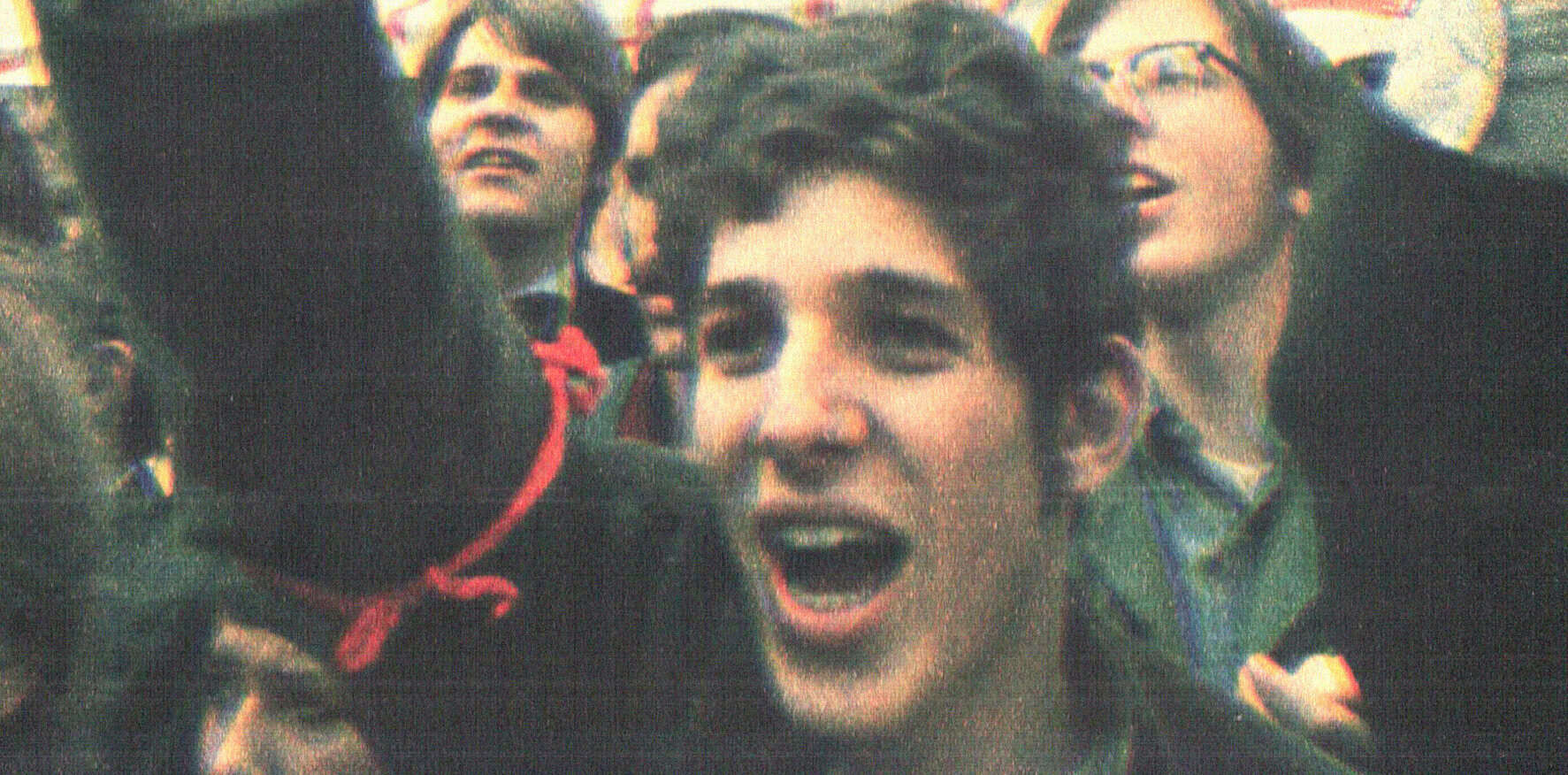 Young woman protesting at a rally, expressing emotions of passion and activism, surrounded by diverse crowd, capturing the spirit of social movements, news, and history coverage.
