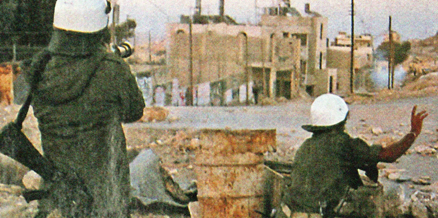 End of conflict in Syria, armed civilians with helmets in a devastated urban landscape, rubble, damaged buildings, tense atmosphere, seeking safety, relief efforts, war zone.