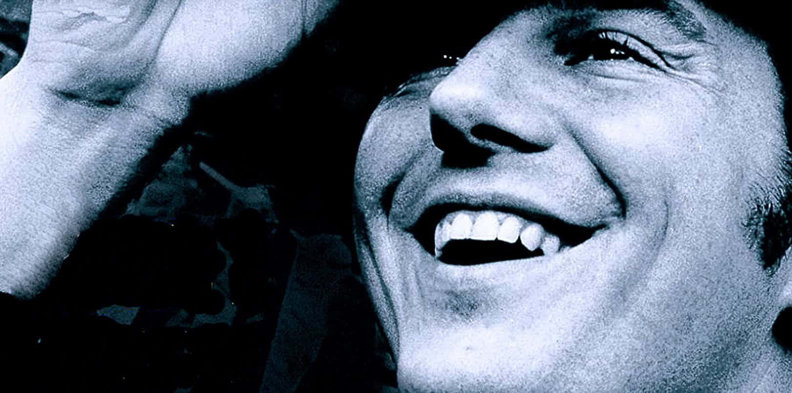 Vivid black and white photo of inspiring woman smiling, capturing joy and empowerment, representing historical and cultural significance in news and music archives.