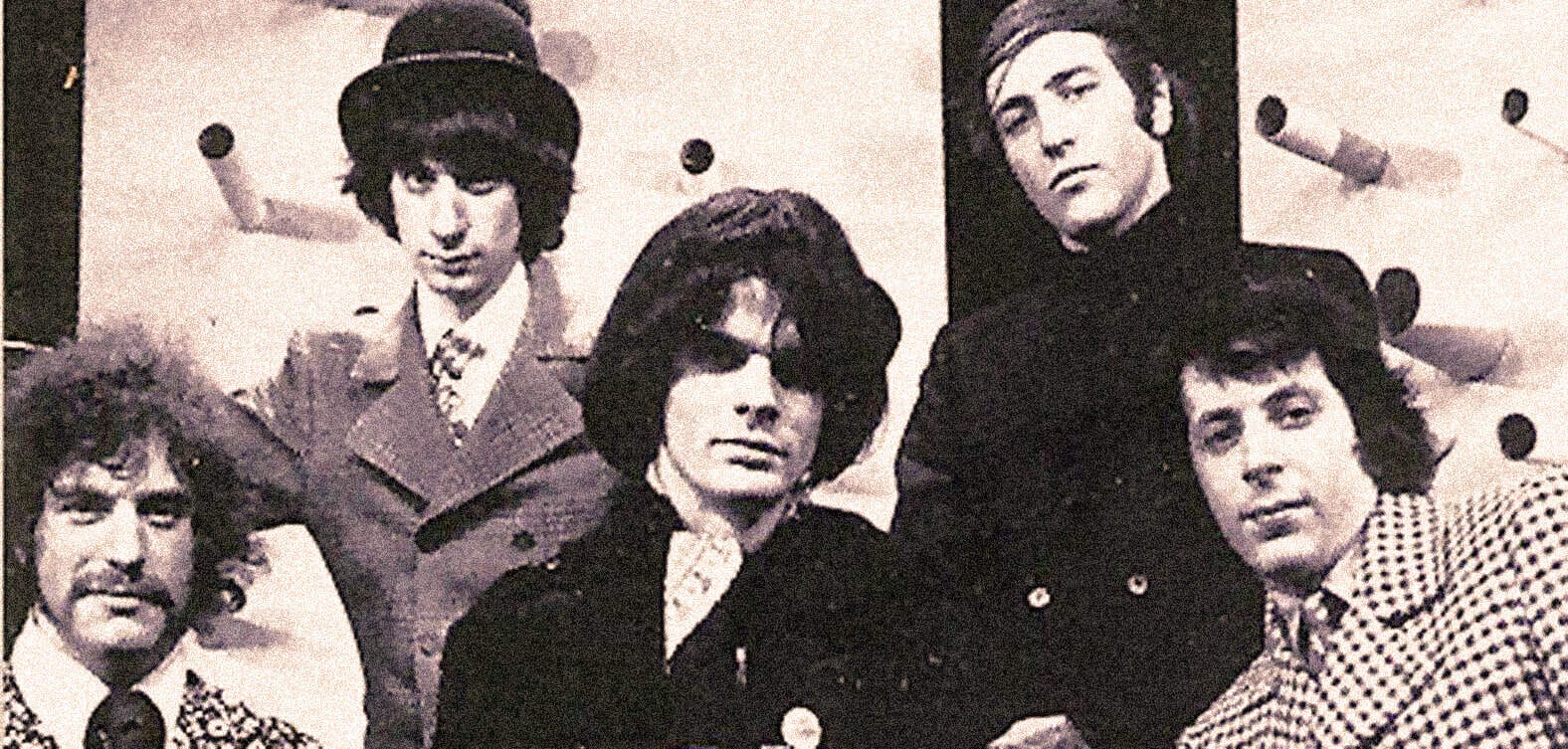 Vintage black and white photo of The Beatles, iconic 1960s rock band, featuring John Lennon, Paul McCartney, George Harrison, and Ringo Starr, during their promotional shoot.