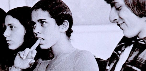 Children listening to a radio broadcast in a classroom, highlighting the importance of historical sound archives, education, and media history.