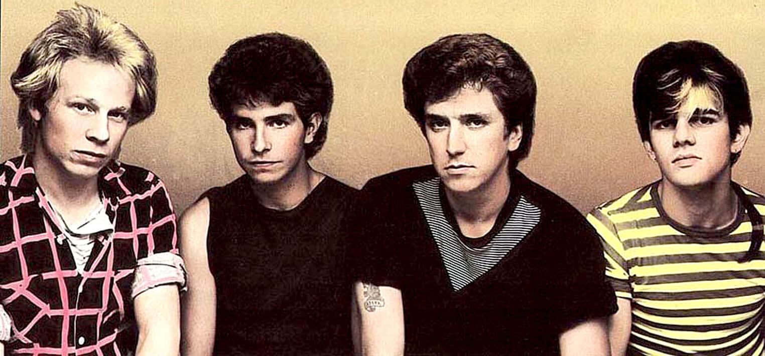 Black and white photo of The Ramones, iconic punk rock band, posing together in casual attire with vintage style. Legendary musical artists known for their influence on punk music and underground culture.