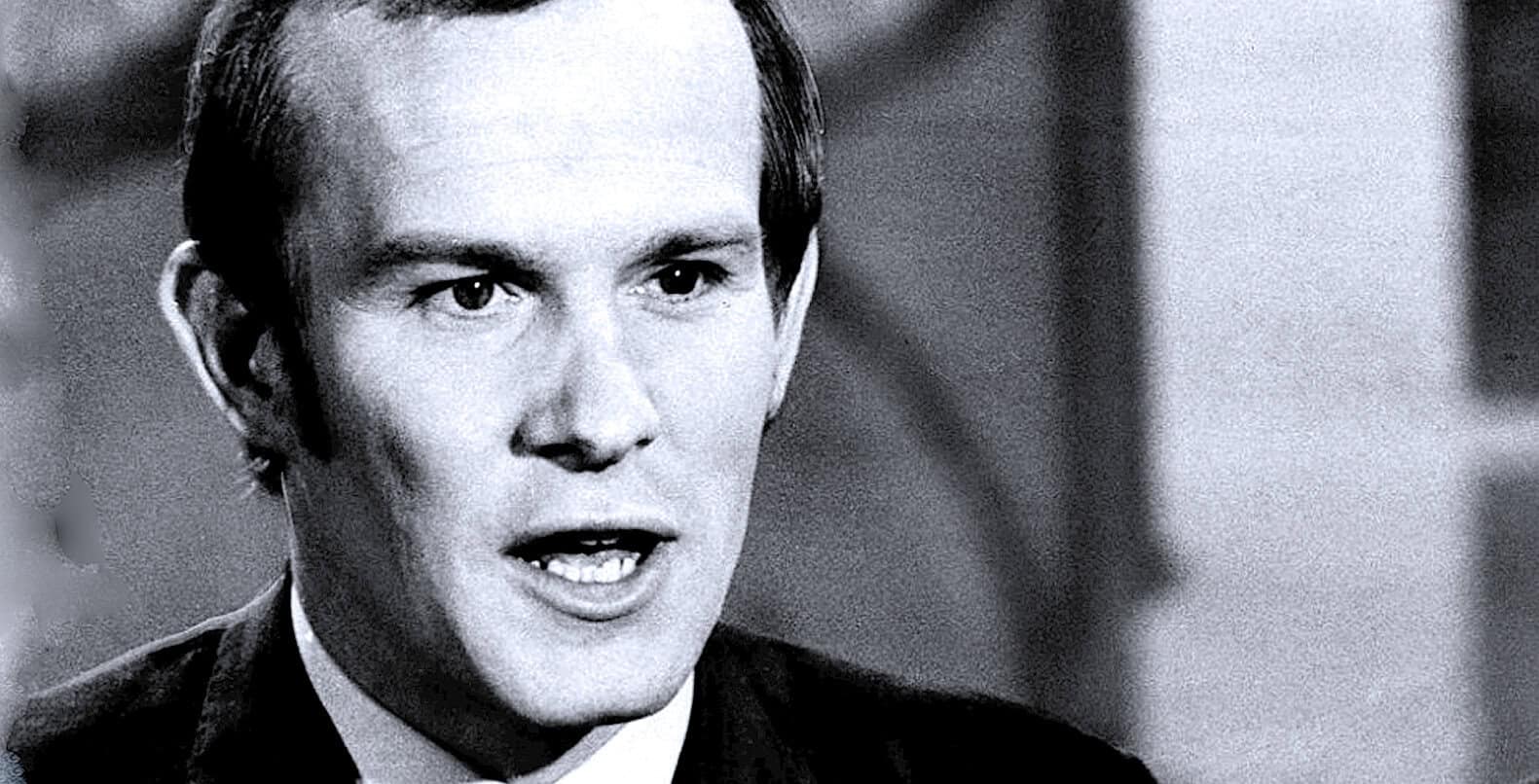 Black and white historical photo of a man speaking, representing news and history archives, suitable for past daily sound archive of news, history, and music.