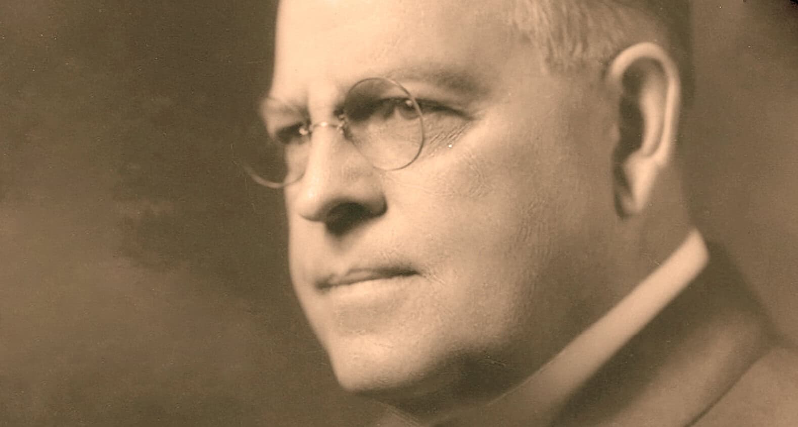 Close-up of Mahatma Gandhi, Indian leader and advocate of nonviolent resistance, with glasses and traditional attire, representing peace and historical significance.