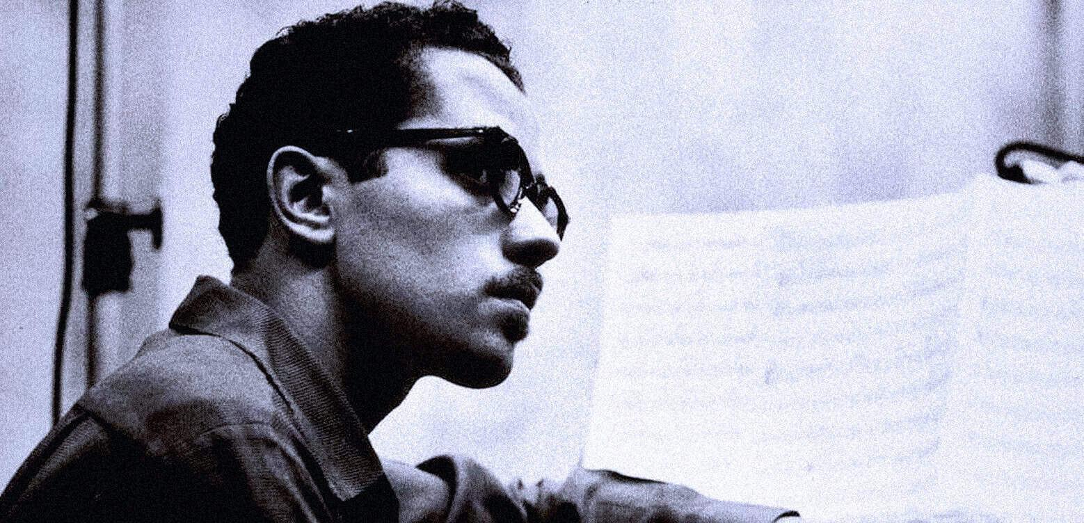 Young man listening to music with headphones, showcasing 1980s nostalgia, vintage style, and cultural history relevance.