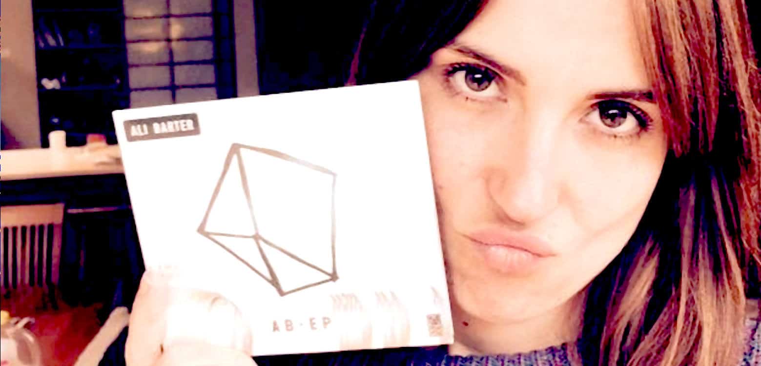 File name: woman-holding-album-cover-past-daily-sound-archive-news-music.jpg.