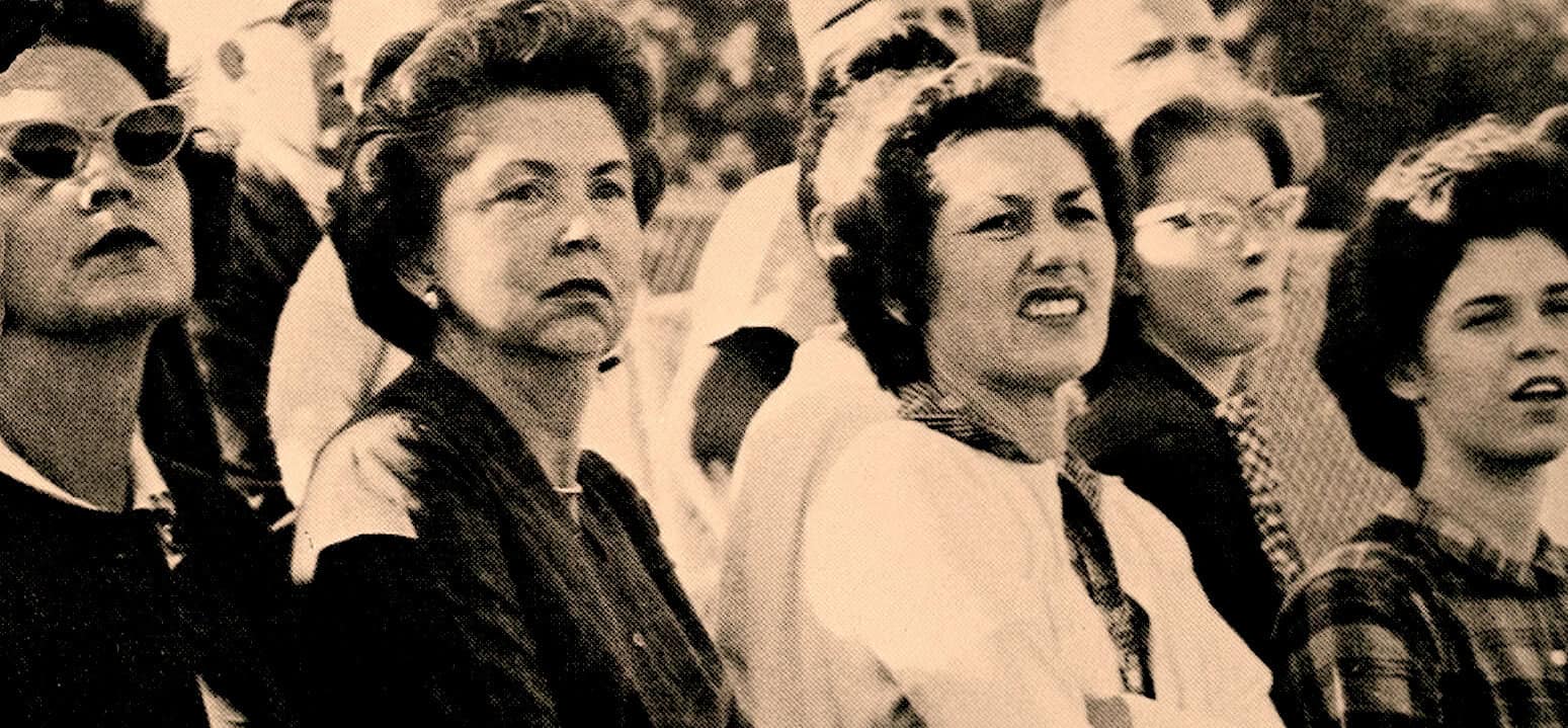 Women protesting during a historical event, vintage black-and-white photo, social activism, women's rights movement, past news archive, documentary image.