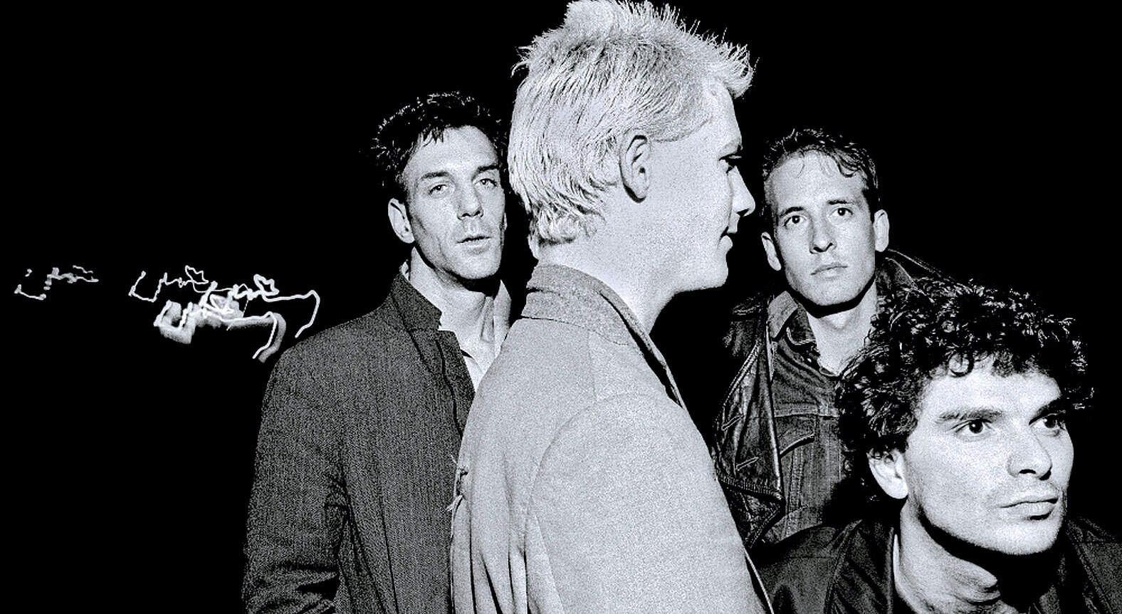 Vintage image of a 1980s band with four members, showcasing alternative rock music and iconic style.