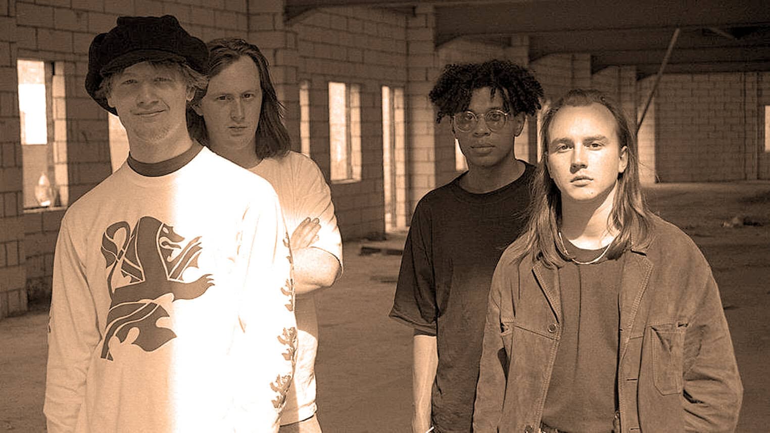 A music band standing in an industrial-style space, representing vintage and modern music themes for a sound archive of news, history, and music.