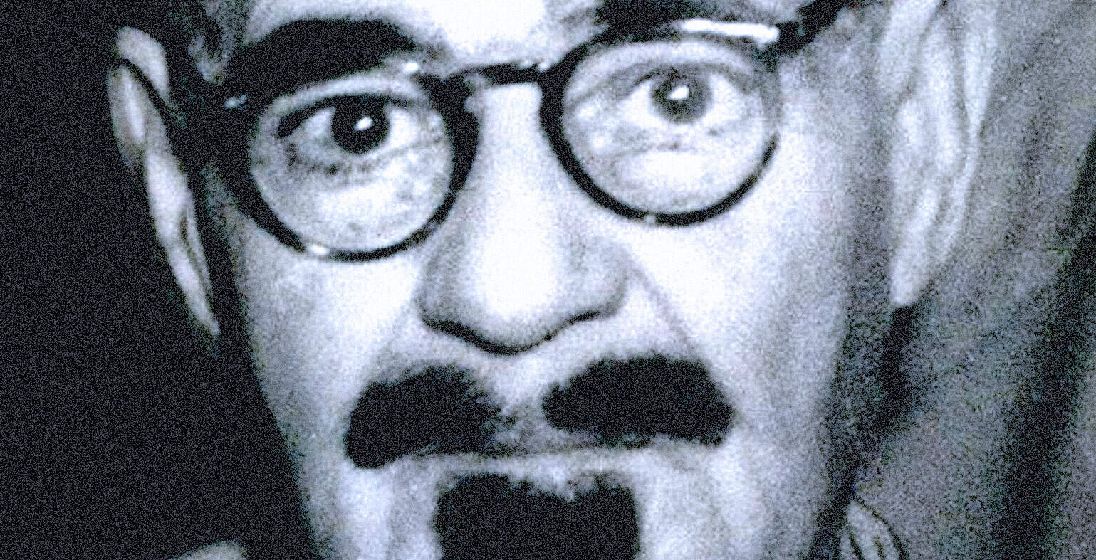Vintage black and white image of a man with glasses, mustache, and surprised expression, highlighting nostalgic news, history, and music archives from Past Daily.