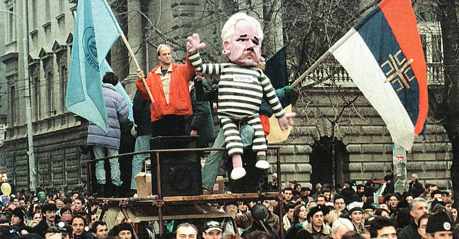 Kaiser Wilhelm II caricature puppet at protest, political satire, historical demonstration, European political event, protest march with flags, political activism, 20th-century history imagery.