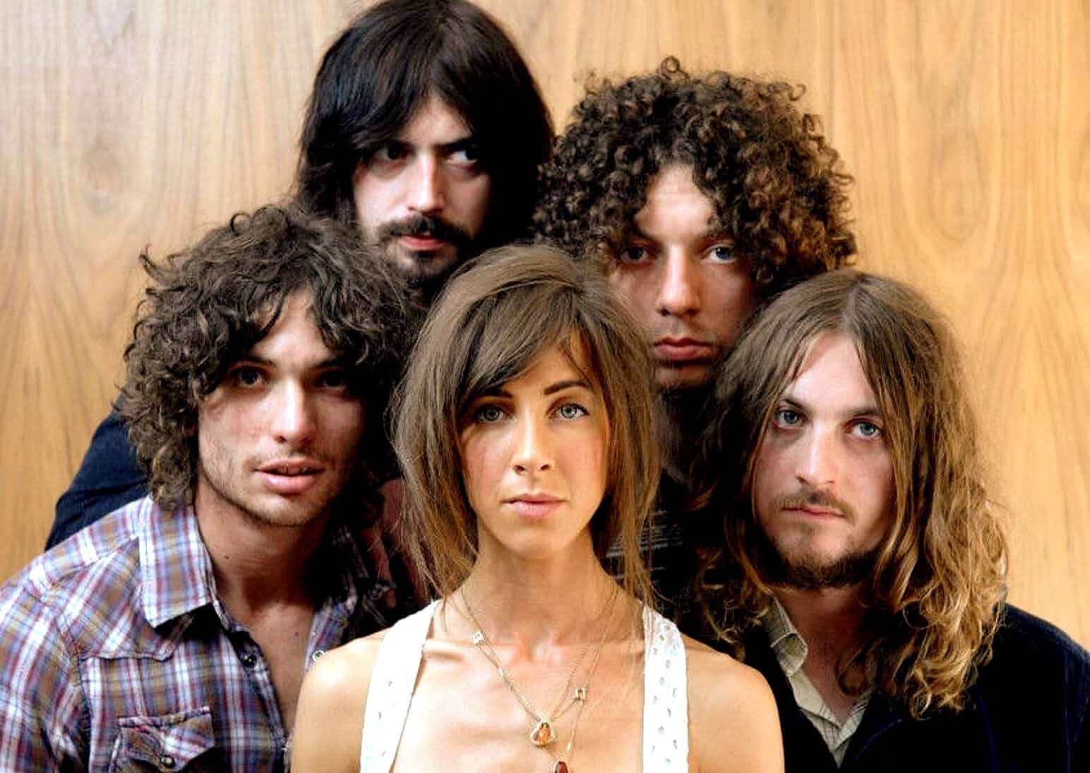 Vintage rock band portrait featuring five members with long hair and bohemian style, representing classic music history and iconic 70s rock culture.