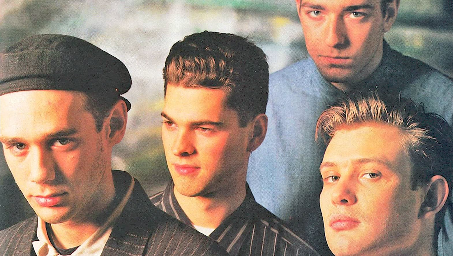 A classic 1950s or 1960s teenage band photo featuring four stylish young men with distinct haircuts and fashion, capturing the essence of vintage music and youth culture.