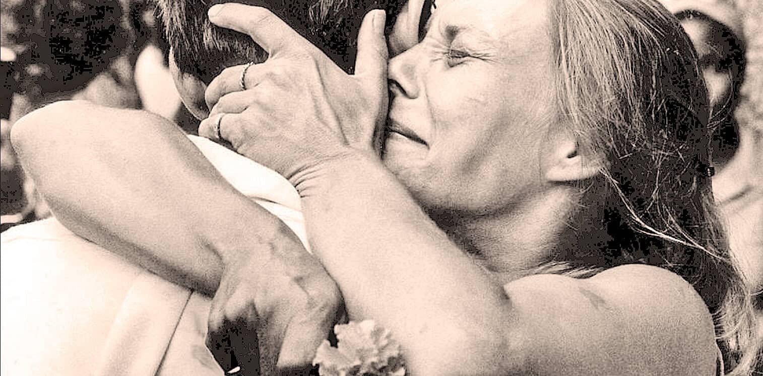 Caring woman hugging a man tightly, expressing love and emotional connection, in a moment of comfort and support at Past Daily: A Sound Archive of News, History, and Music.