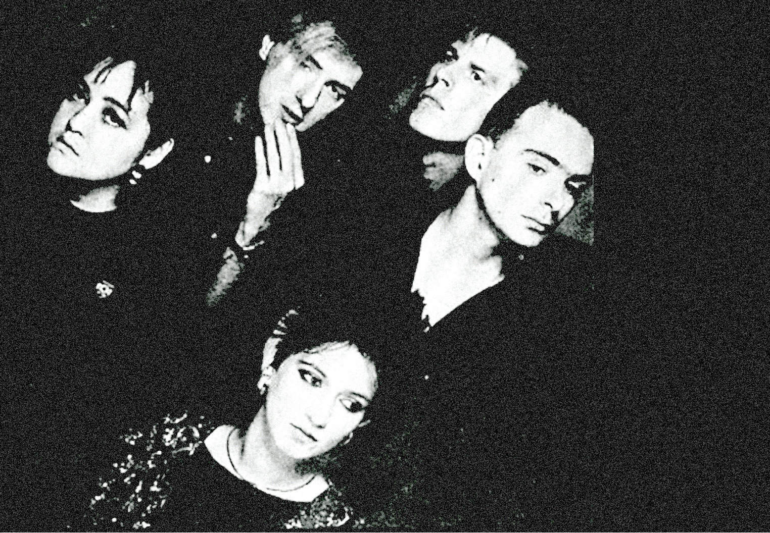 Black and white photo of a diverse music band or group, featuring young female and male members with expressive poses, emphasizing their connection to music, news, and cultural history from Past Daily archive.