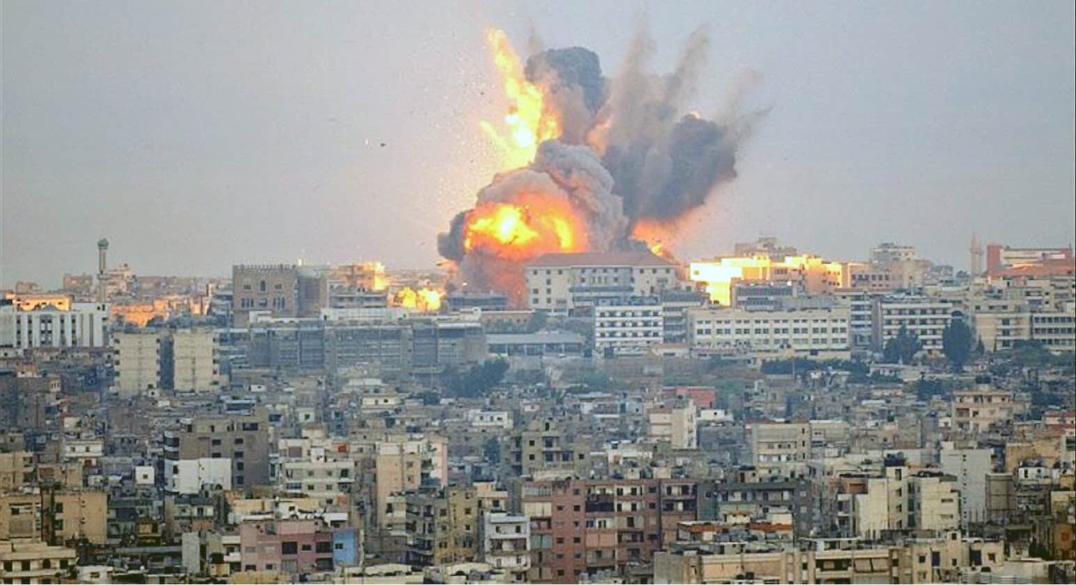 Explosive explosion over city buildings with thick smoke and flames, captured during a major news event, highlighting urban war zones, conflict, and historic moments from news archives.