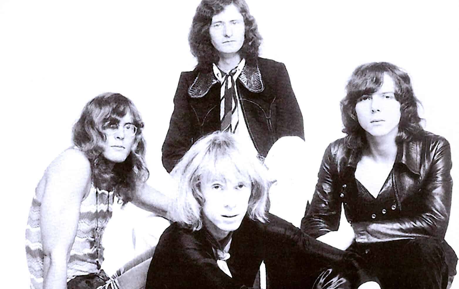 Vintage black and white photo of iconic rock band members with classic hairstyles, representing music history, news, and sound archives from Past Daily.