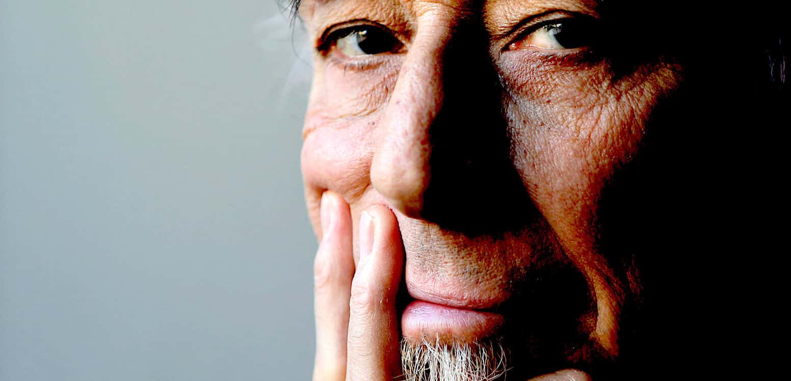 Close-up of an older man's face with a contemplative expression, emphasizing wisdom and life experience, relevant for news, history, and music archive collections.