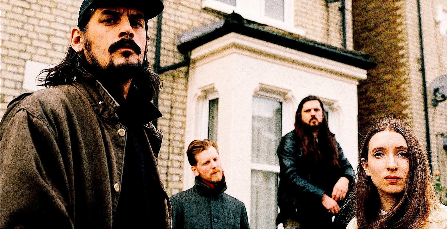 Deep rock band members outdoor street scene, rugged musicians with serious expressions, urban architecture background, alternative music style, high-resolution photo.