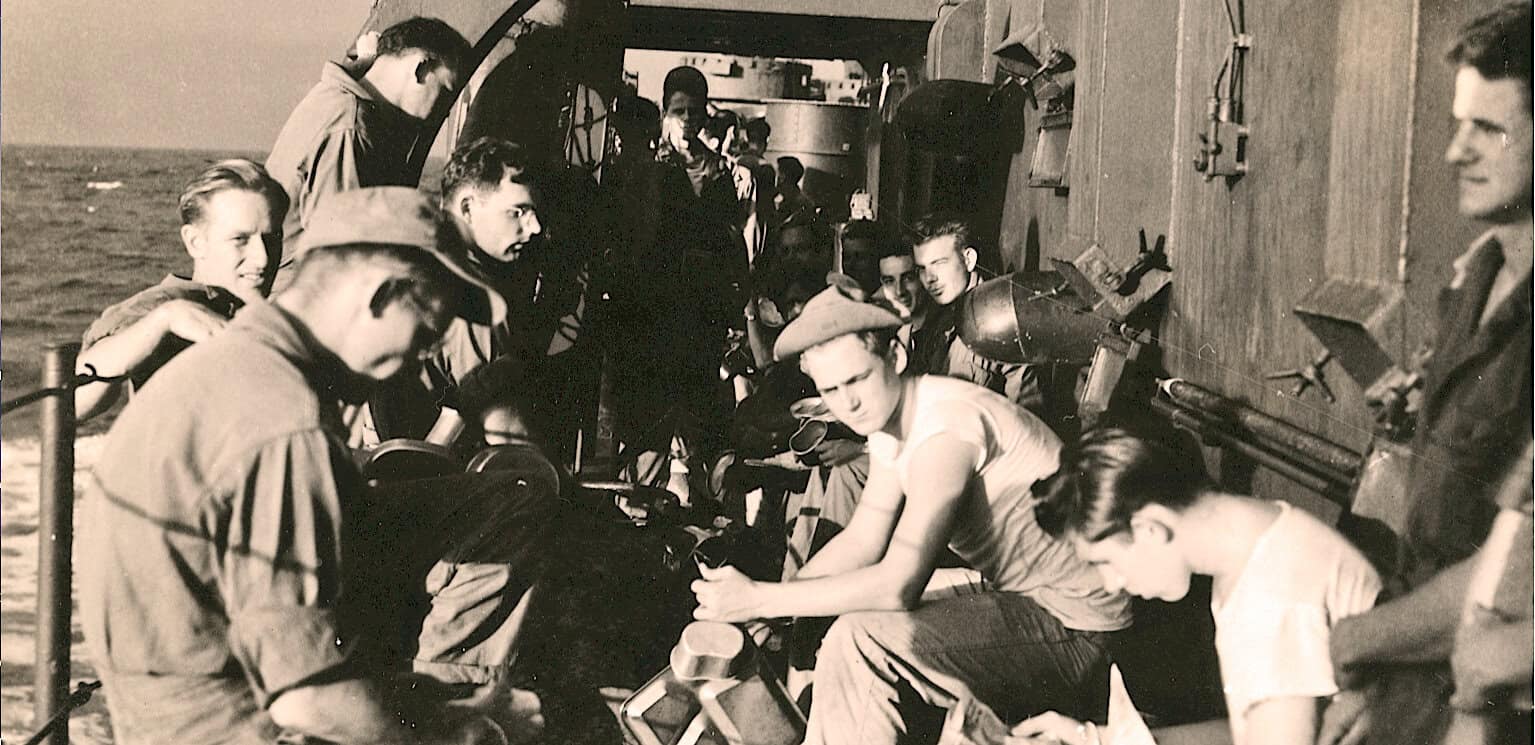 Submarine crew during WWII era, preparing for mission, vintage black and white photo of sailors on a submarine deck.