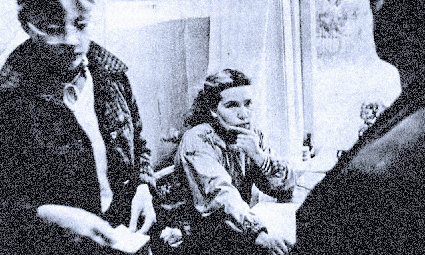 Historic black and white photo of young women in a discussion, representing news, history, and music archives at Past Daily.