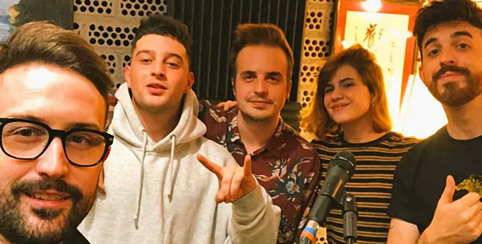 Young adults singing and playing music in a cozy indoor setting, promoting nostalgic music and radio archives, capturing community, culture, and history for Sound Archive of news, history, and music.