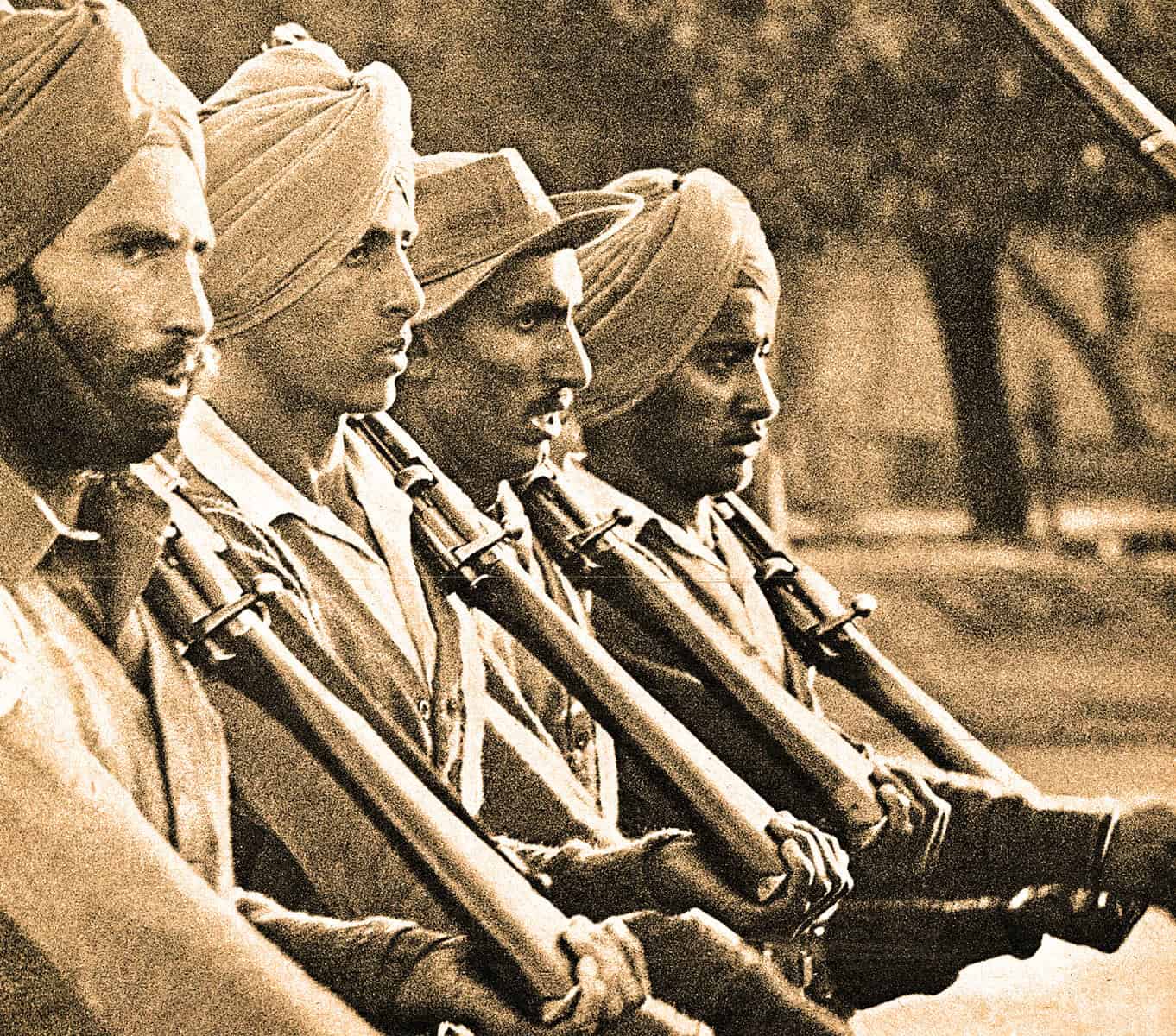 Women soldiers wearing turbans holding rifles, historical military personnel, representing bravery and diverse forces, black and white vintage photograph.