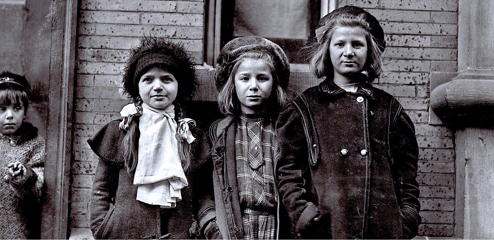 School children standing outdoors in vintage black and white photograph, historical photo capturing childhood innocence, early 20th-century fashion, nostalgia for past eras.