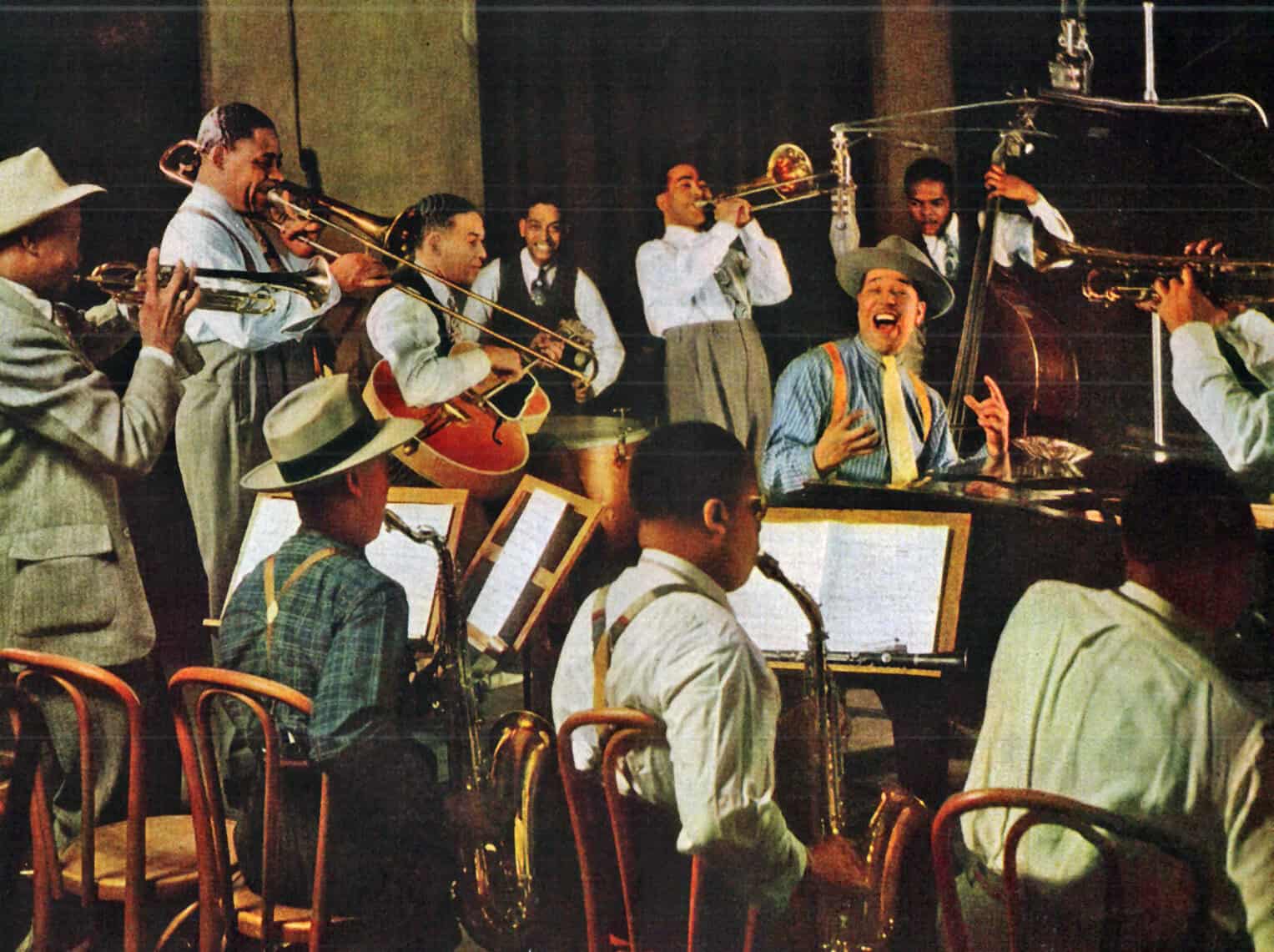 Jazz band performing live with multiple musicians playing trumpets, saxophones, piano, and guitar, capturing vintage music scene, news, and cultural history for sound archives and music preservation.