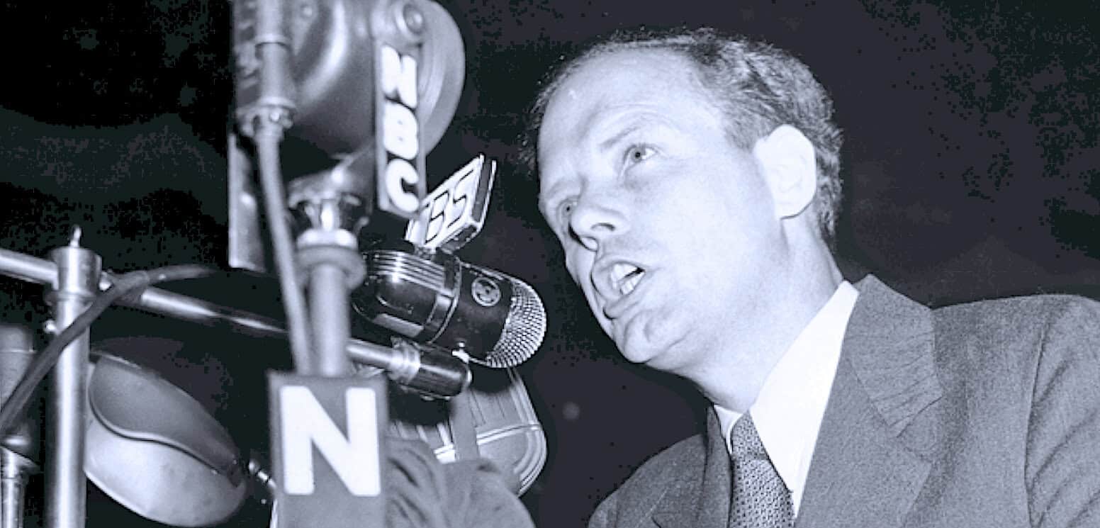 Unique black and white photo of a passionate radio news broadcaster speaking into a microphone, capturing the essence of historical news reporting and classic radio studio atmosphere.