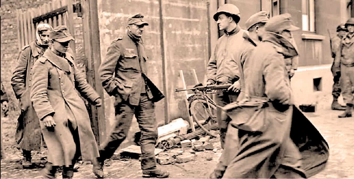 German soldiers walking through a war-torn street during World War II.